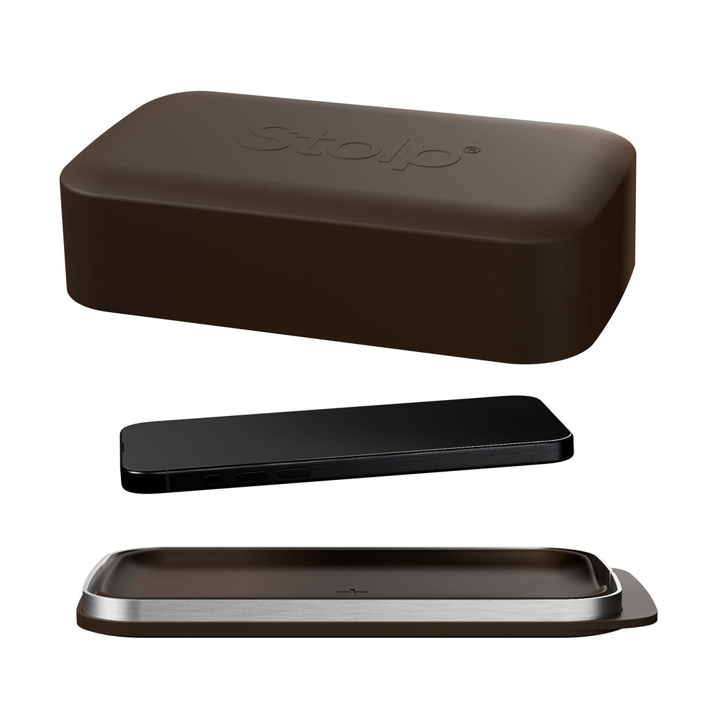 Three rounded rectangular objects in dark brown, black, and brown-silver on white surface