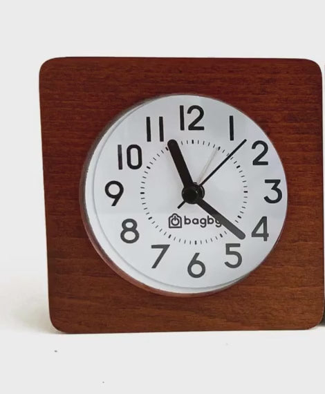 Video: a square wooden Bagby alarm clock on a plain white background, demonstrating the sound the alarm makes.